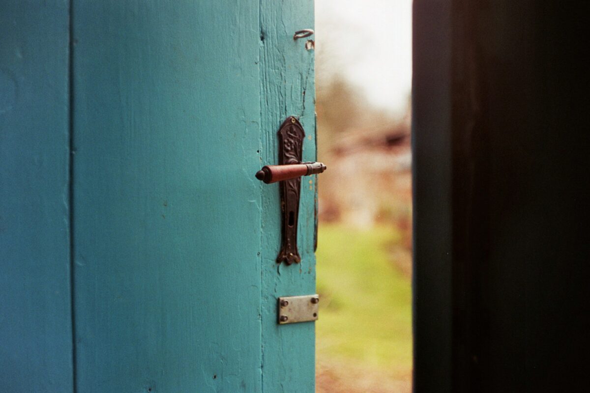 A blue door opening to the outside to demonstrate the endless opportunities that exist