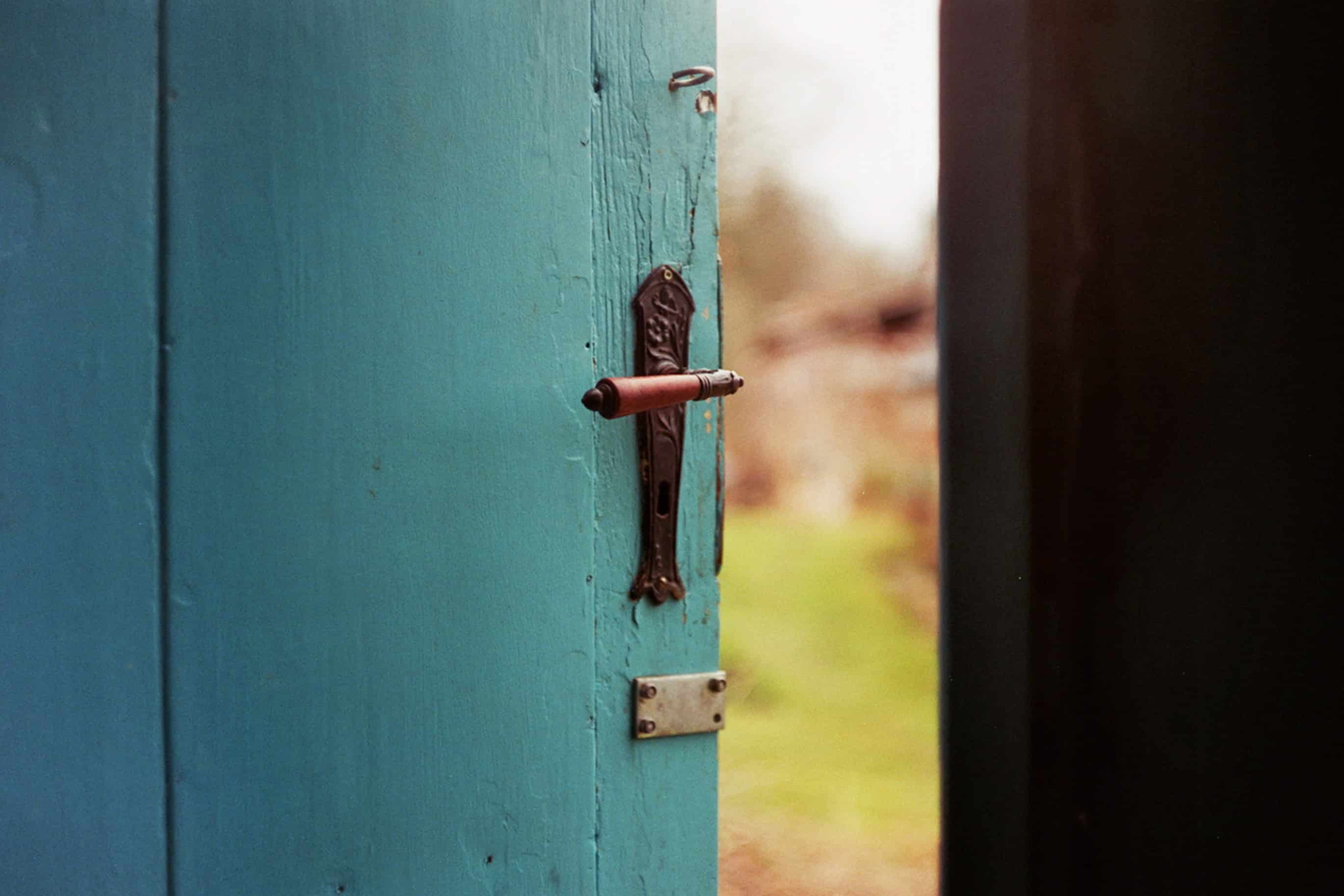 A blue door opening to the outside to demonstrate the endless opportunities that exist