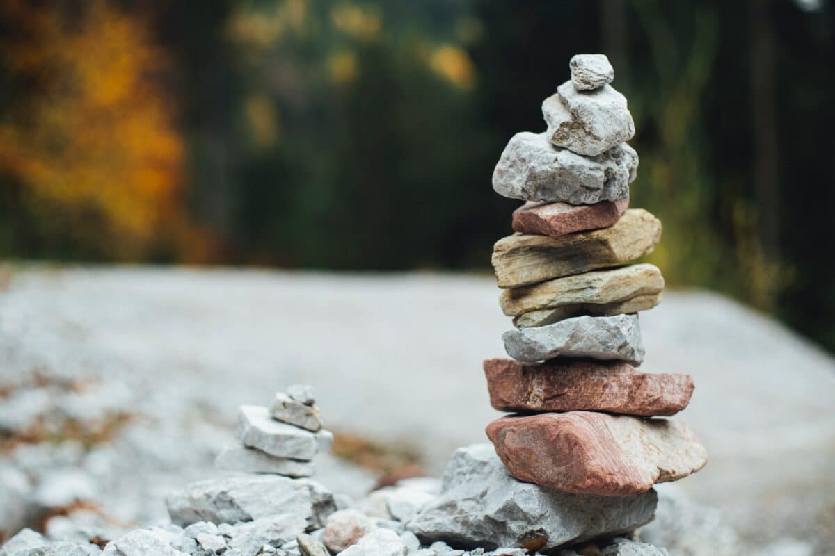 A pile of rocks sitting on one another demonstrating the value of balance while accepting the discomforts of life