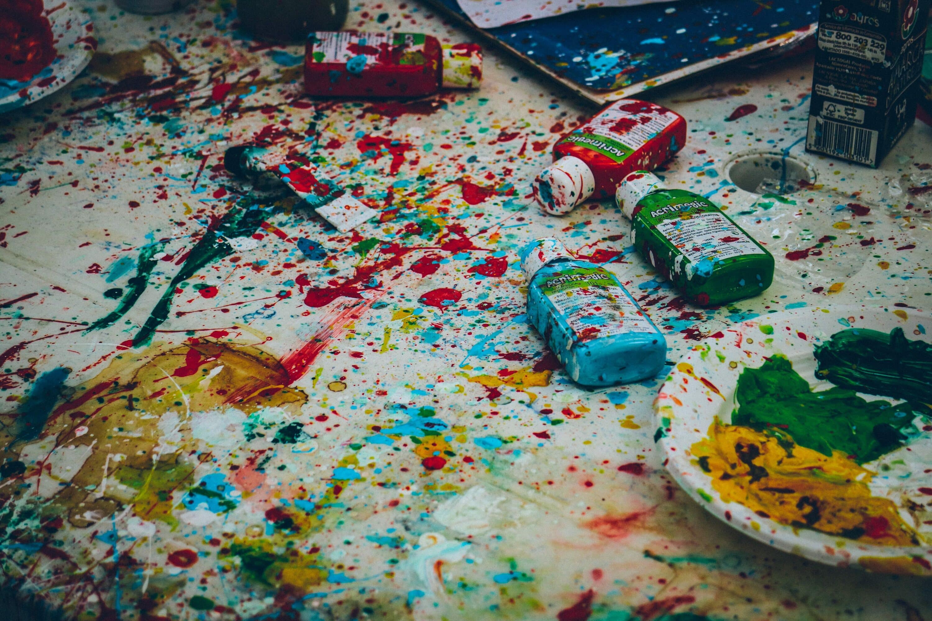 Paint splatters and bottles on a floor